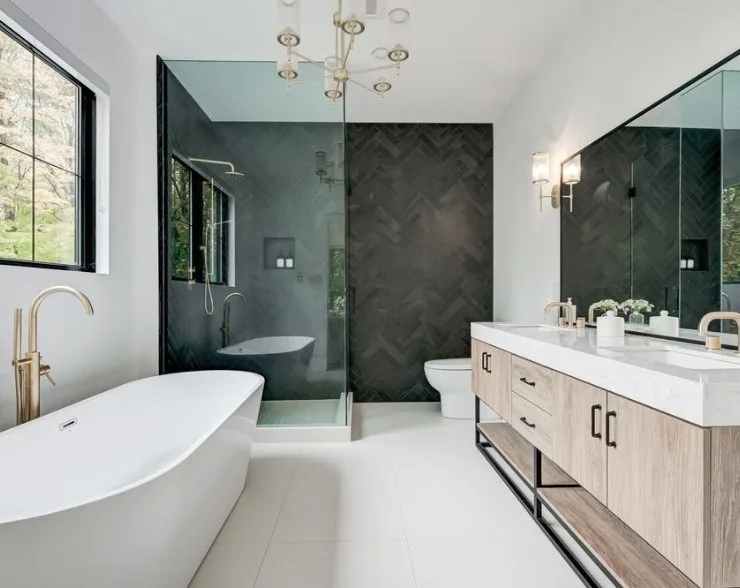 Modern bathroom with dark tile and freestanding tub